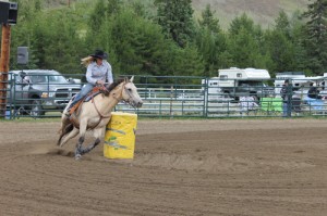 Canoe Mountain Rodeo had a good showing of locals in the stands this weekend, and in the fifteen BC Rodeo Association sanctioned events. Saturday offered non-stop action from 1pm to well after 7 pm. Local riders included Kelsey Griffin competing in the Ladies Barrel Racing, Alissa Byford competing in Junior Barrel Racing, and Madison Smith and Taleigha Tinsley Dawson both competing in the Pee Wee Barrel Racing. Madison Smith also competed in Pee Wee Pole Bending.  The Duncan Girls beat Snowfarmers in a demonstration Pack Horse Race on Saturday, and Snowfarmers tailed again on Sunday against the Burstrom/Cardinal team, amidst good natured ribbing from the announcer.  The rain let up in time for the action to start on Sunday, with Terri Pallagi of McBride competing in the Saddle Bronc Riding and Stacy Duncan competing in Ladies Barrel Racing. Contestants came from as far away as Chilliwack, Osoyoos, Quesnel and Vanderhoof, some even traveling through the weekend to participate in the Pritchard Rodeo as well as Valemount. One contestant, Steve Hohmann of Quesnel, competed in 5 events on Sunday with a broken cheek and jaw (injuries sustained 5 weeks ago at another rodeo, when a bull landed on him). He was the only rider to go the 8 seconds on a Bronc on Sunday. Chinook Riders, a youth Drill Team from Hinton provided the Grand Entry and Intermission shows.  See A10 for photos.