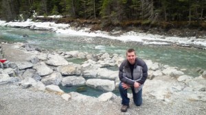 Valemount Mayor Andru McCracken kneels next to the geothermal pools at Lussier Hot Springs, some 25 km south of Fairmont Hot Springs. Photo submitted