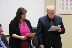 Counc. Robert Callaghan reads his oath of office in December.