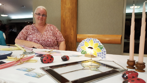 Photo by Laura Keil Hollie Blanchette had a table at the  home-based business mini trade show at the Chamer of Commerce meeting last week. She showcased her stained glass and her daughter’s beeswax candles.