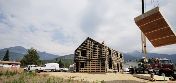 Valemount's first Passive House is set to be completed in spring 2016. In this summer 2015 photo, a crane lifts a roof panel. The pre-fab building envelope took 3 days to assemble.