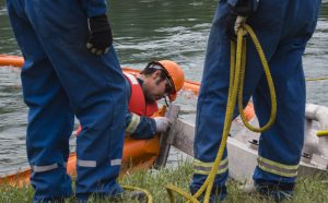 The purpose of the booms is to guide the oil toward the mouth of the decontamination unit where a skimmer is set up. The skimmer collects oil on the water’s surface, but inevitably some water is taken out with the oil, as it’s not separated. / EVAN MATTHEWS