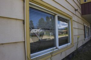 More than one window was smashed out at the Mountainview Apartments, this one around the back. / EVAN MATTHEWS