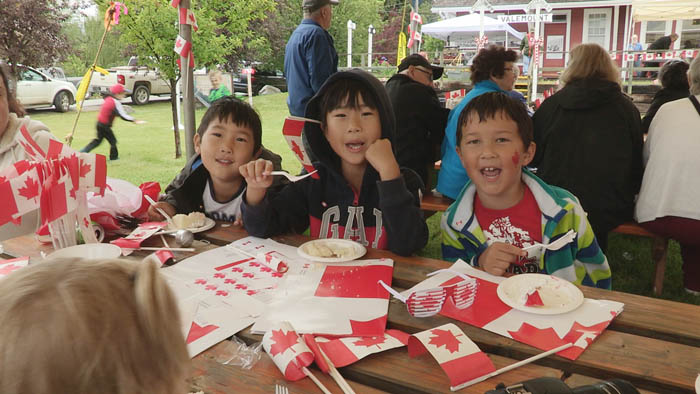 Noah and William Kim and Jayden Han took a moment from eating Canada Day cake to smile for the camera