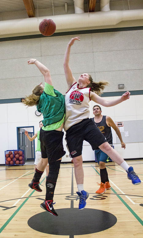 Katlyn Jensen (green) tips off against her coach and mentor for the week, Linnaea VanderZwan.