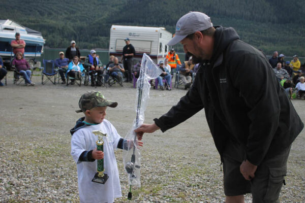 Mason Lewis is presented his trophy by Marina Association president, Owen Torgerson. Lewis won the 6 and under category. 