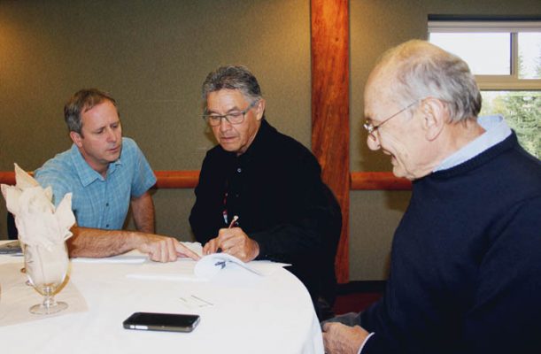 Photo: Evan Matthews Simpcw Chief, Nathan Matthew (middle), signs the Impact and Benefit Agreement with VGD, Oberto Oberti (right) signed for VGD.