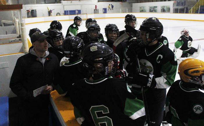 The Edmonton team gets a pep talk from their coach prior to the championship.
