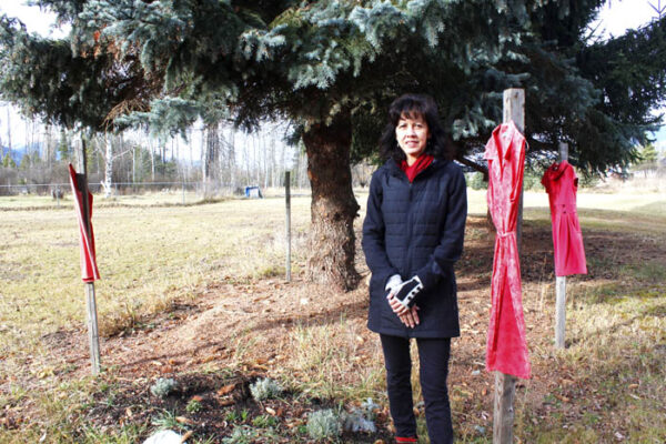 Photo: Evan Matthews The fence post in the distance is empty, Tinsley says, in memory of the first dress she ever hung in memory of MMIW outside her shop. One evening, someone took the dress, which she says felt like someone stole that girl all over again.