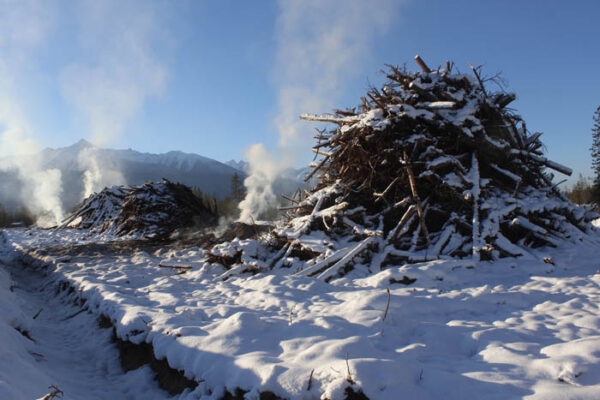 Photo: Evan Matthews These are just two of eight smuldering slash piles counted at the time of the photo.