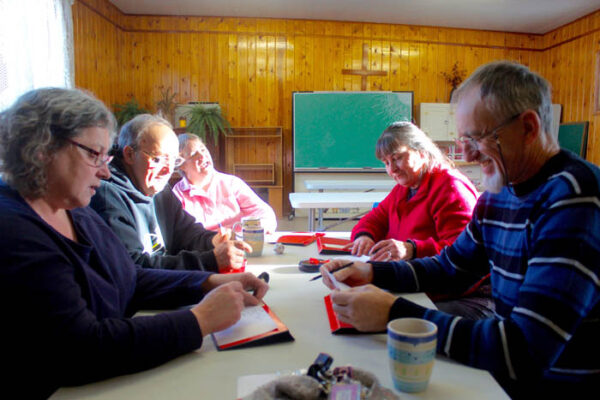 Photo: Evan Matthews Ellen Duncan, Art and Mimi Guiltner, Marian Plummer and Maurice Hill are seen playing Scategories during the first drop-in this winter at the Valemount Anglican Church. Not pictured: Laura Johnson, founding member.