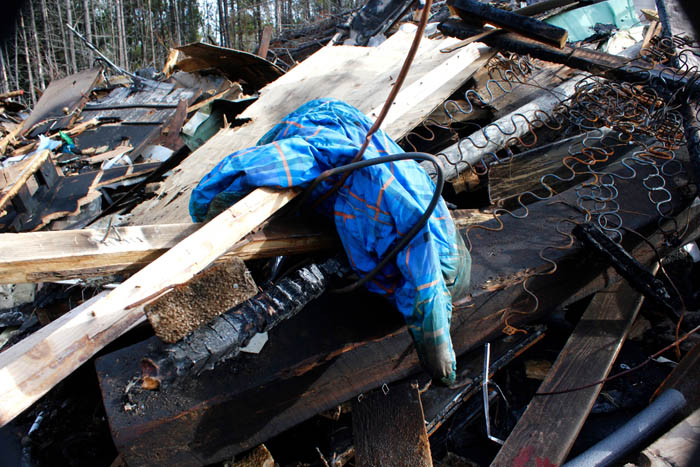 Neighbours irked by trailer fire debris in shared marshland